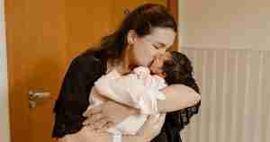 A woman holds her baby.